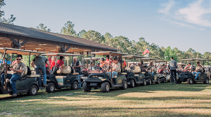 large group of people on golf carts for sunshine kids foundation fundraiser
