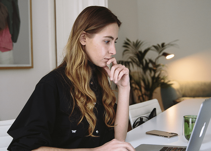 woman on laptop searching real estate keywords for seo
